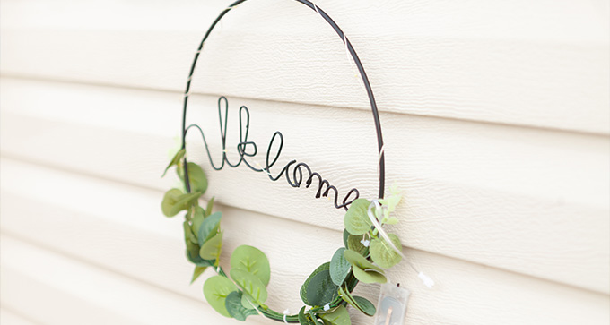 a welcome sign made of wire on the side of The Salty Air Retreat's caravan